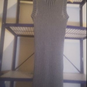 A long grey sleeveless sweater